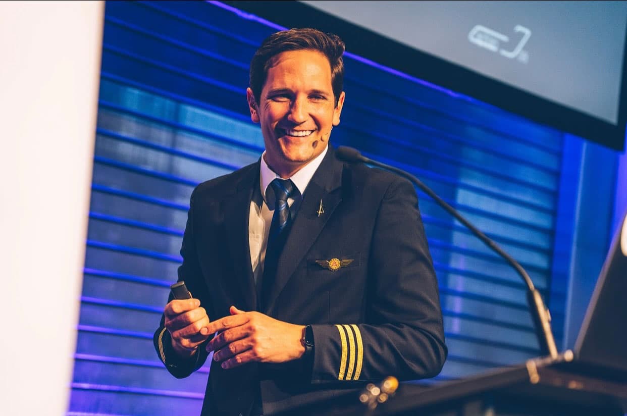 Captain Joe delivering a keynote speech at a corporate event - 2x TEDx speaker and aviation expert