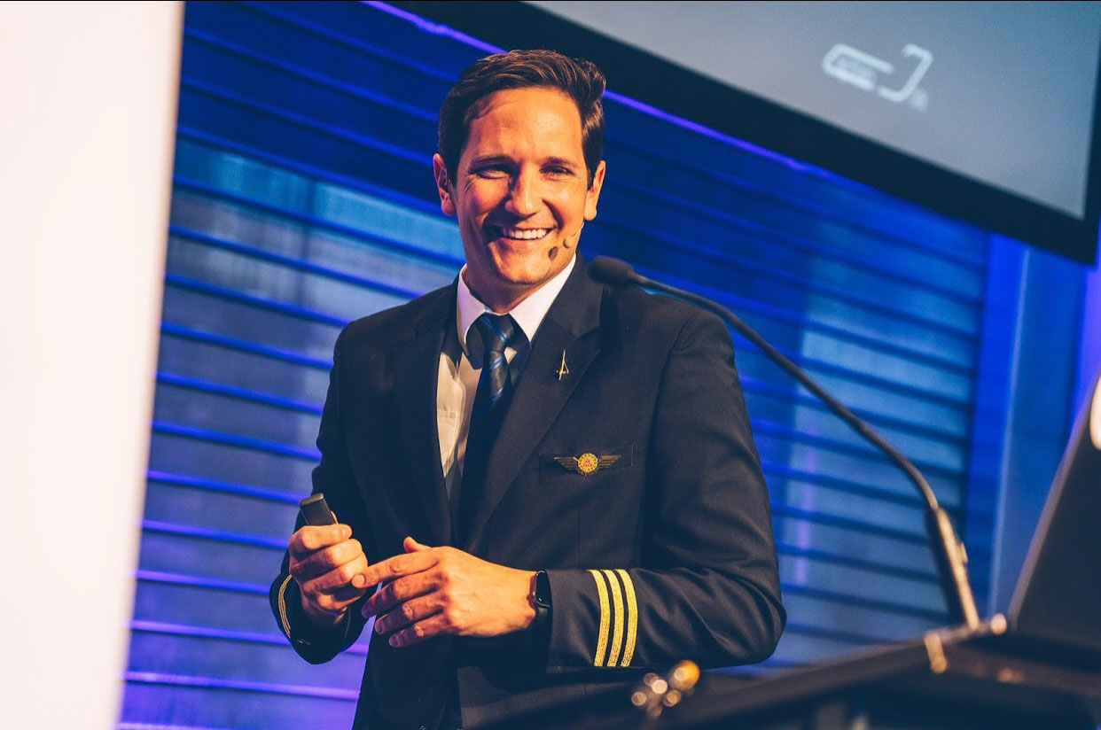 Captain Joe delivering a keynote speech at a corporate event - 2x TEDx speaker and aviation expert