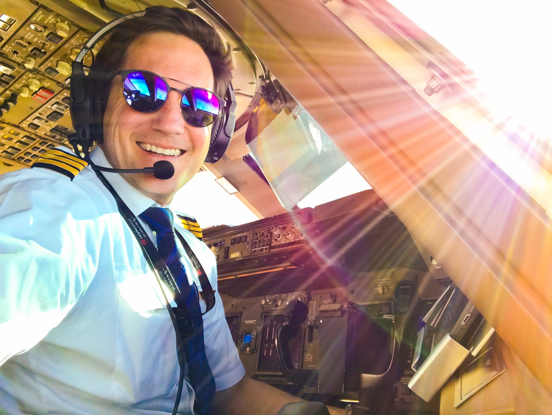 Captain Joe in the cockpit with sunset light streaming through the windshield - Aviation YouTuber with 1.7M+ subscribers